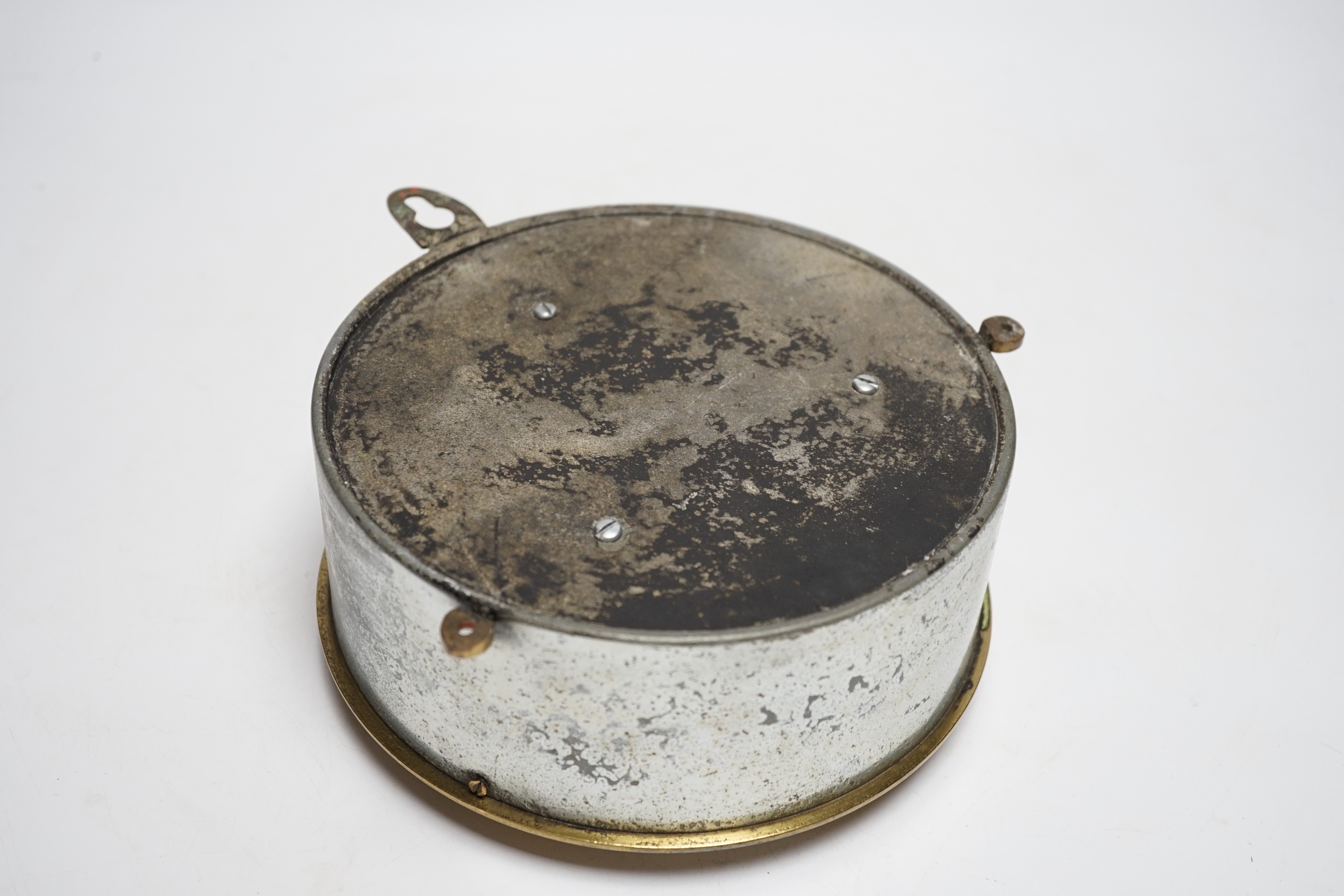 A ship's cylindrical brass two train bulkhead clock, 18.5cm diameter